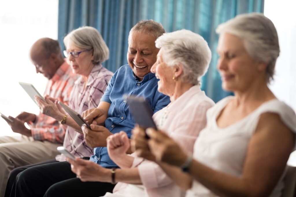 Gardens at Shadow Hills | Seniors smiling and using tablets